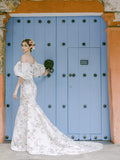 Woman wearing Monique Lhuillier Fall 2022 fitted ivory and floral print Amalia gown with billowed sleeve