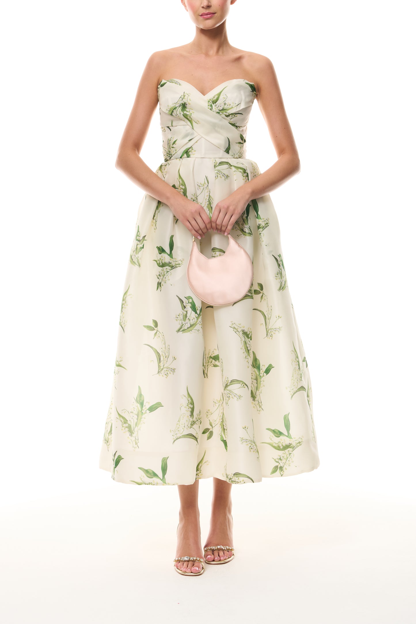 Monique Lhuillier Florette Silk White/Leaf Lily of the Valley-printed organza midi-length dress from The Bridal Edit - front with blush Demi Evening Bag.