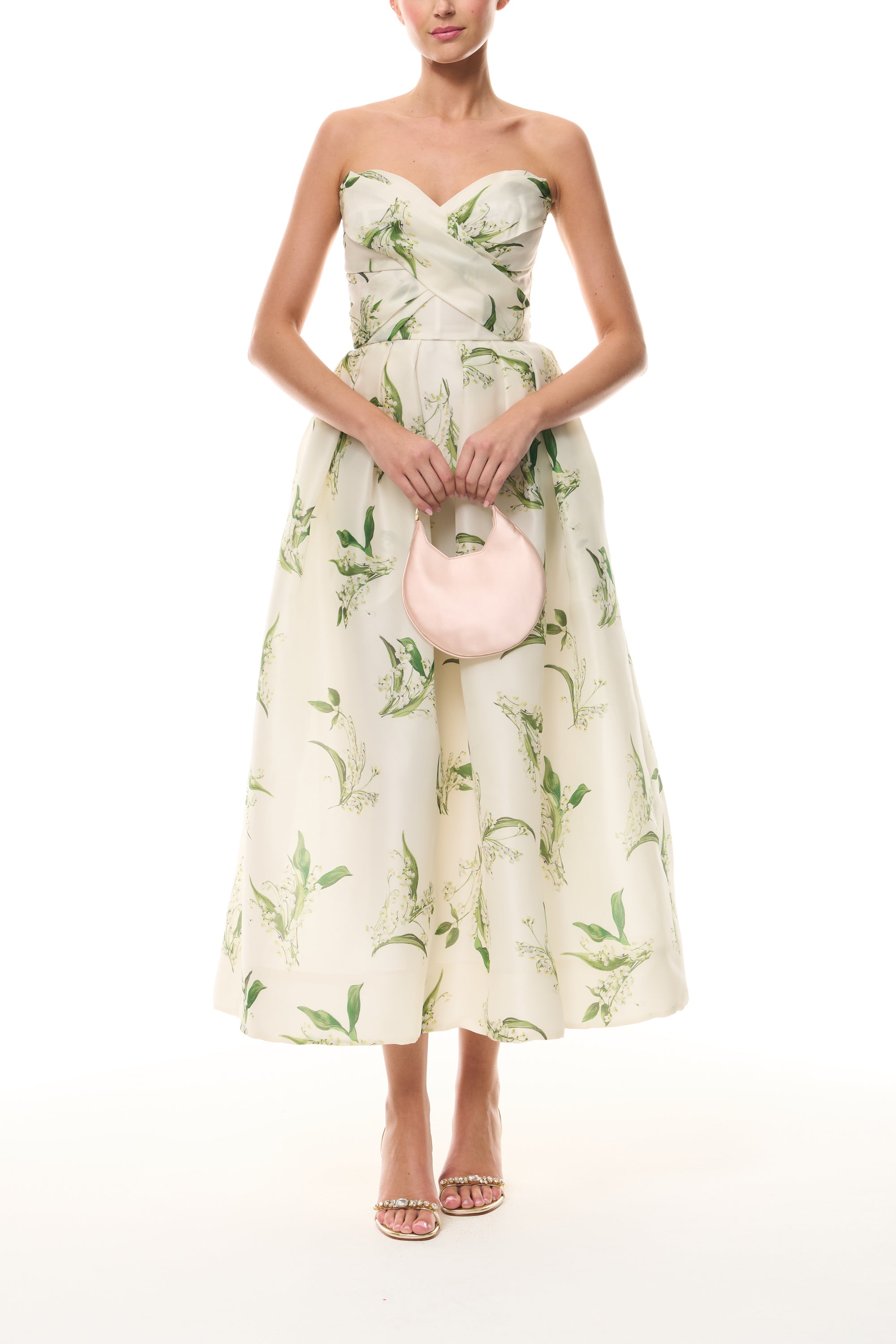 Monique Lhuillier Florette Silk White/Leaf Lily of the Valley-printed organza midi-length dress from The Bridal Edit - front with blush Demi Evening Bag.