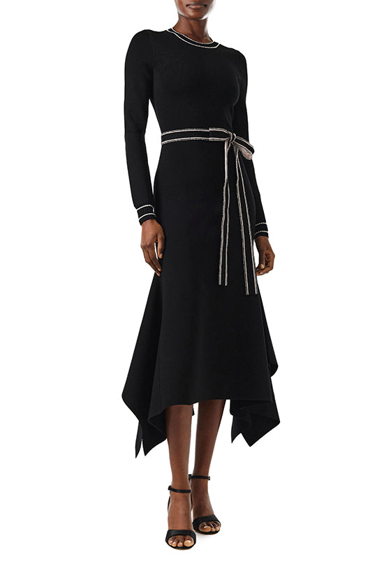 Monique Lhuillier Fall 2024 black knit long sleeve dress with handkerchief hem and self-tie belt - front two.