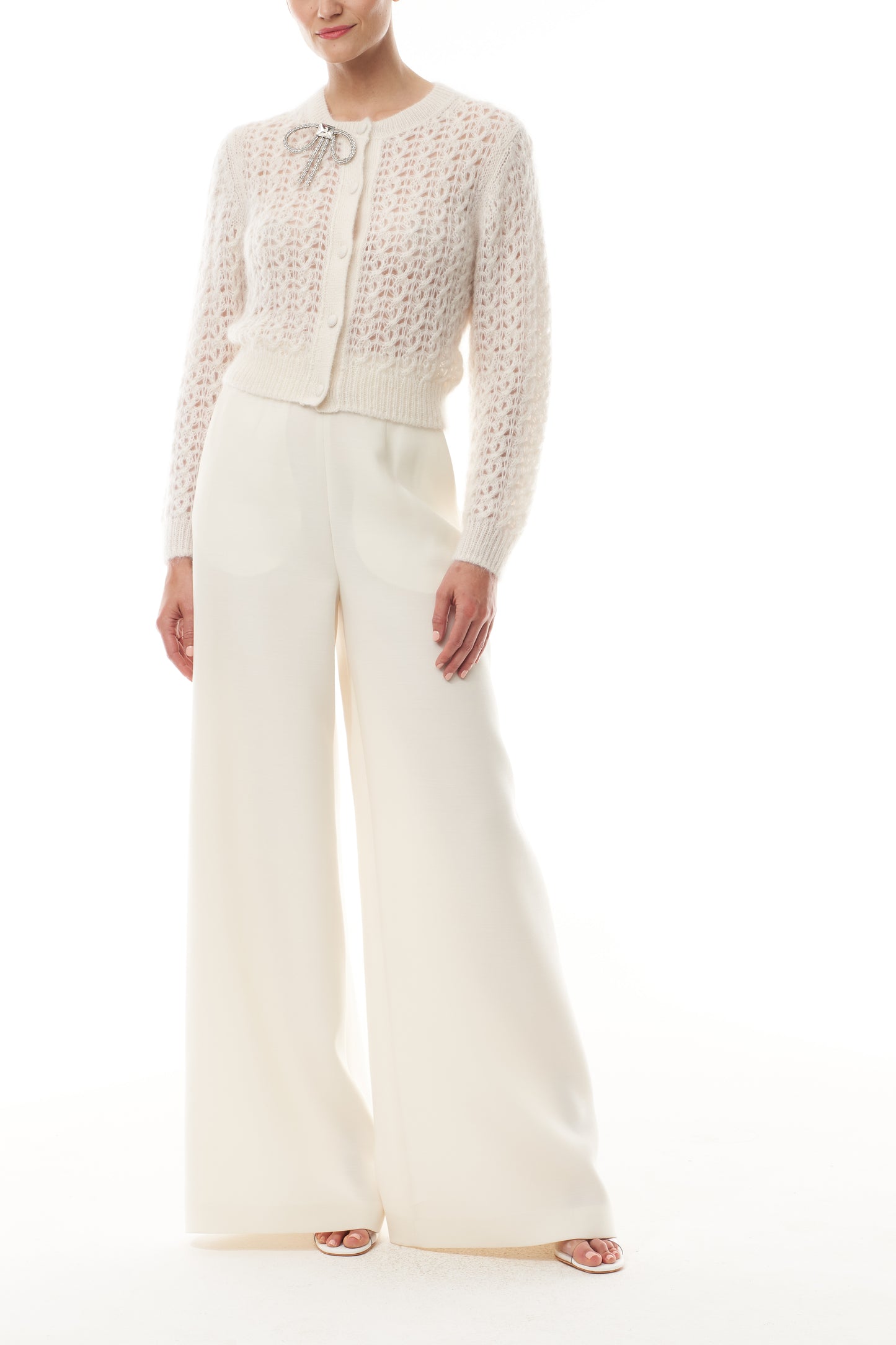 Monique Lhuillier Fall 2025 Mohair Silk Cashmere cardigan with bow brooch and white wide leg trouser- front.