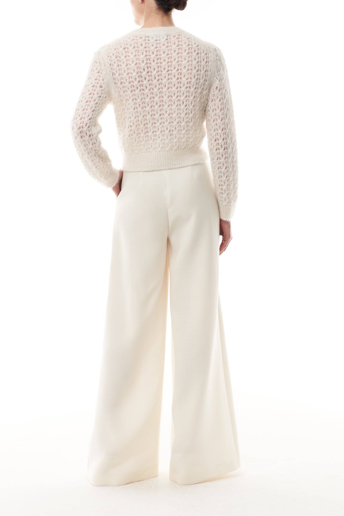 Monique Lhuillier Fall 2025 Mohair Silk Cashmere cardigan with brooch and white wide leg trouser- back.