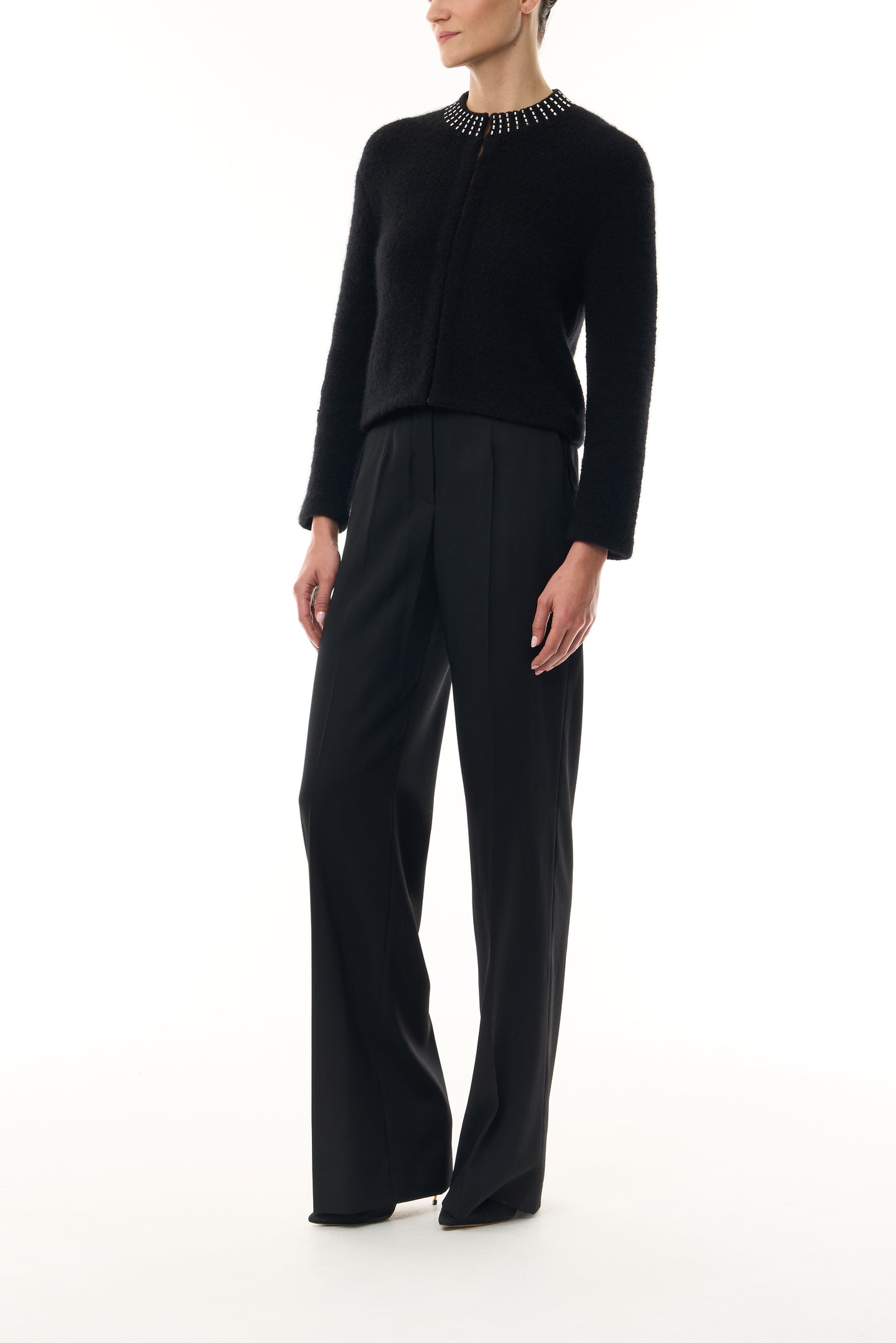 Monique Lhuillier Fall 2026 Noir bouclé knit jacket with crystal trim neckline and hook and eye closures - side.