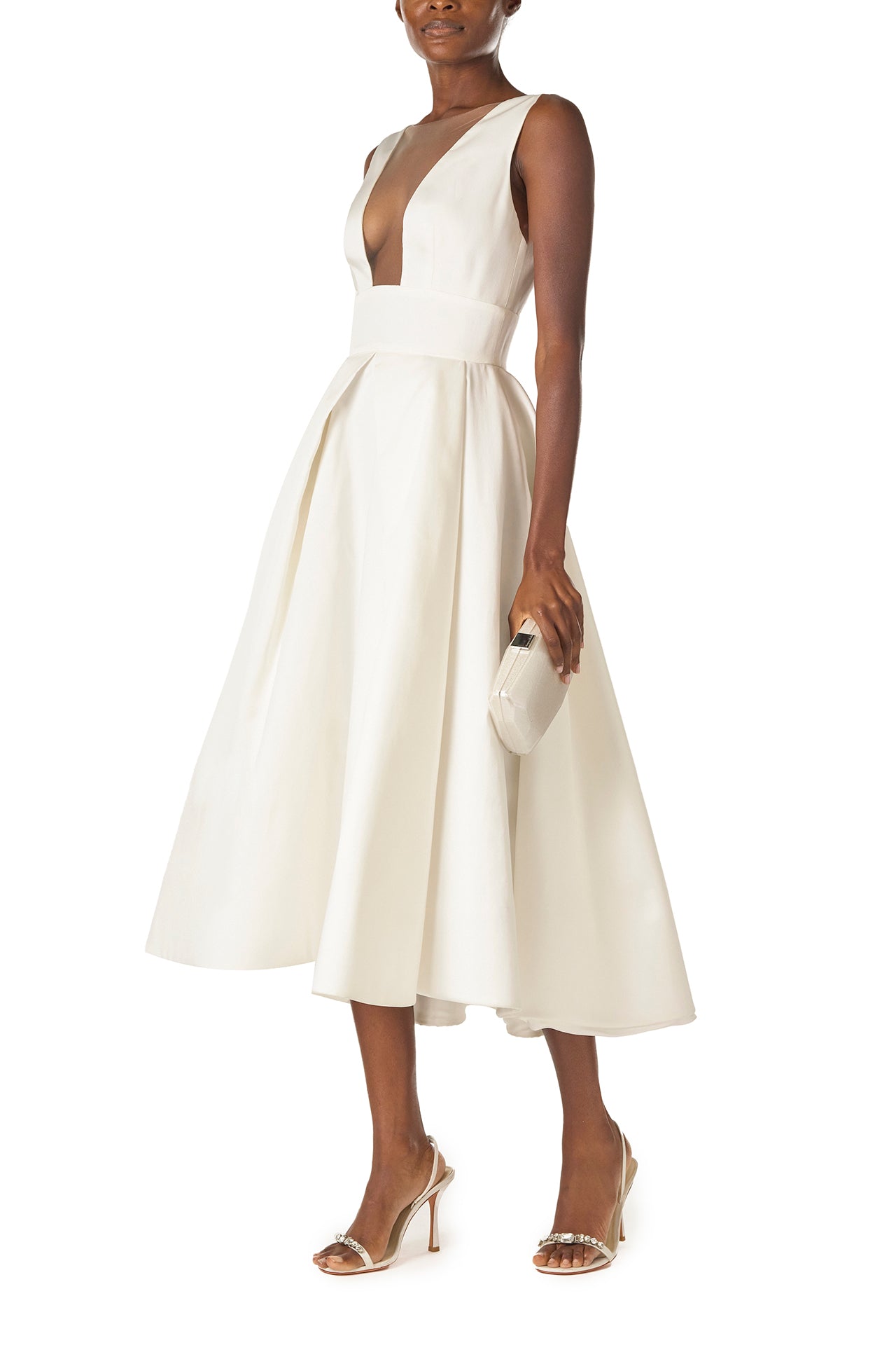 Monique Lhuillier "Kennedy" V-neck cocktail dress in Silk White Mikado fabric with pockets and nude illusion tulle at neckline - left side with Dasha bag.