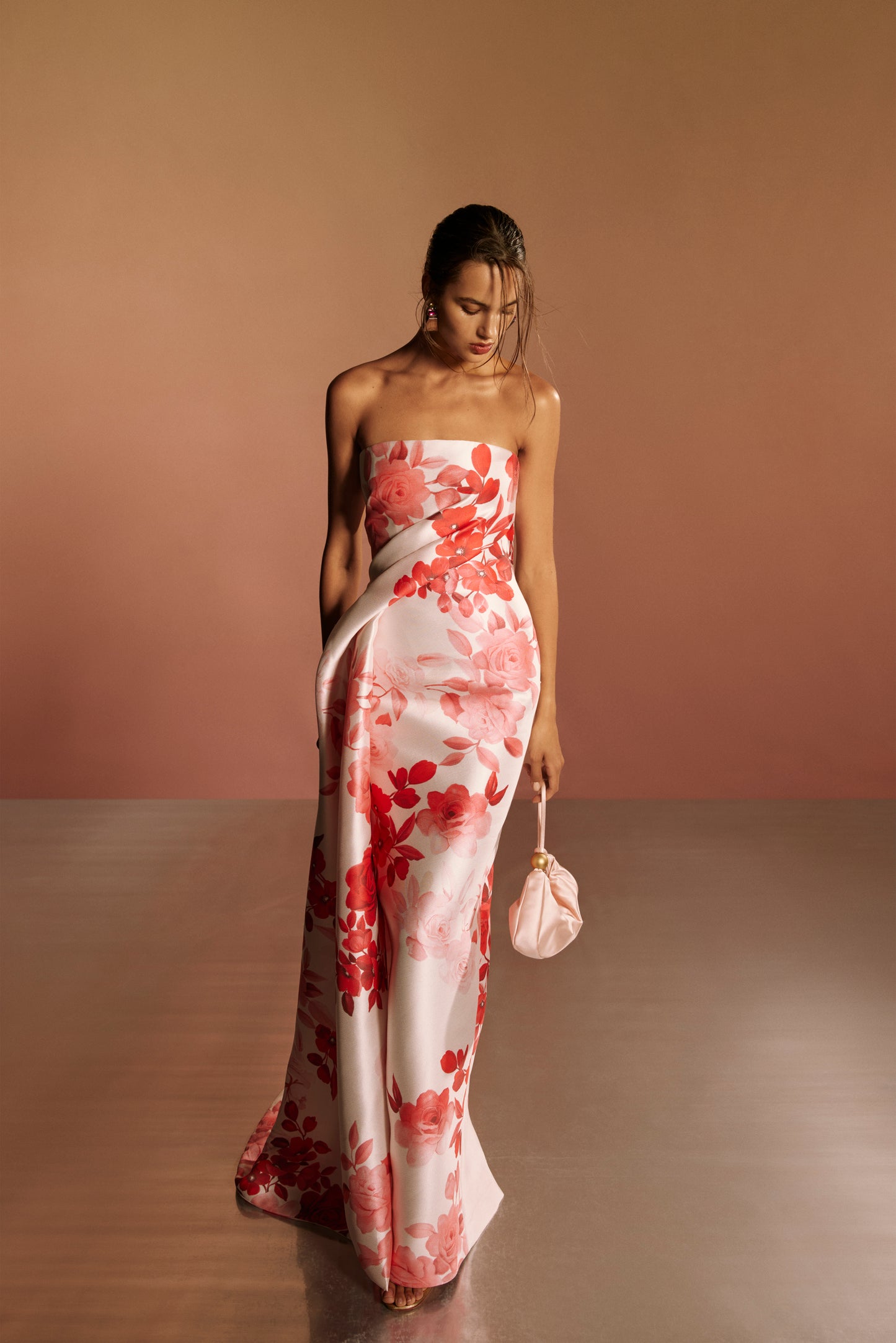 Monique Lhuillier Spring 2026 lookbook image - model wearing pink and white rose ombre printed satin strapless draped column gown