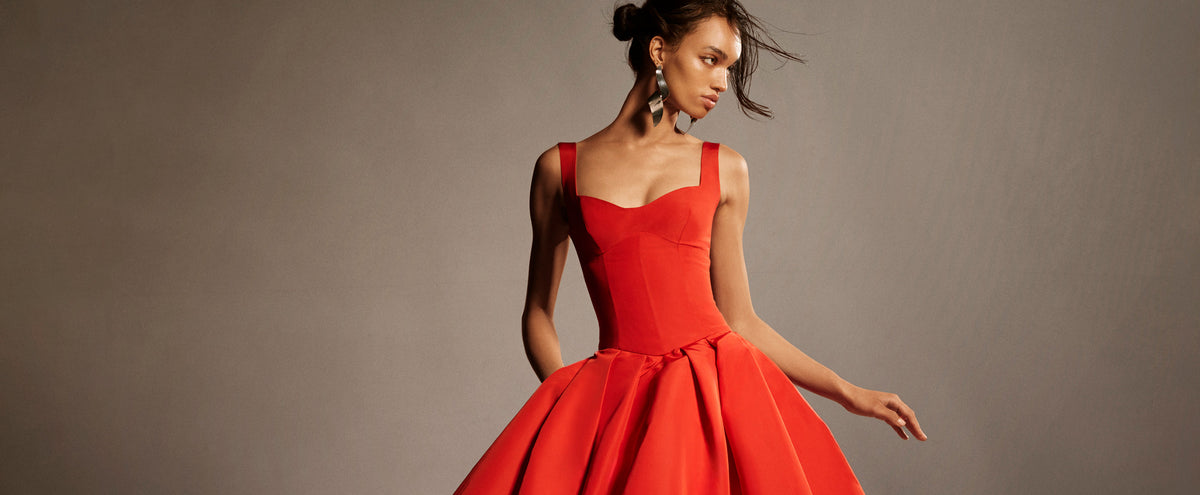 Monique Lhuillier Spring 2026 lookbook image - model wearing Poppy faille scoop neck basque waist pleated ballgown
