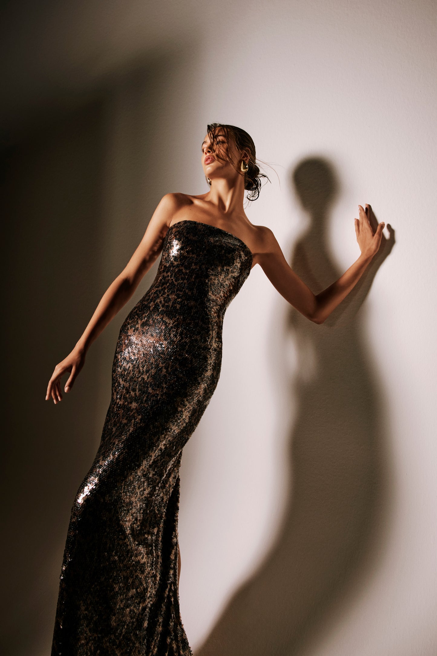 Monique Lhuillier Spring 2026 lookbook image - model wearing leopard sequin strapless column gown