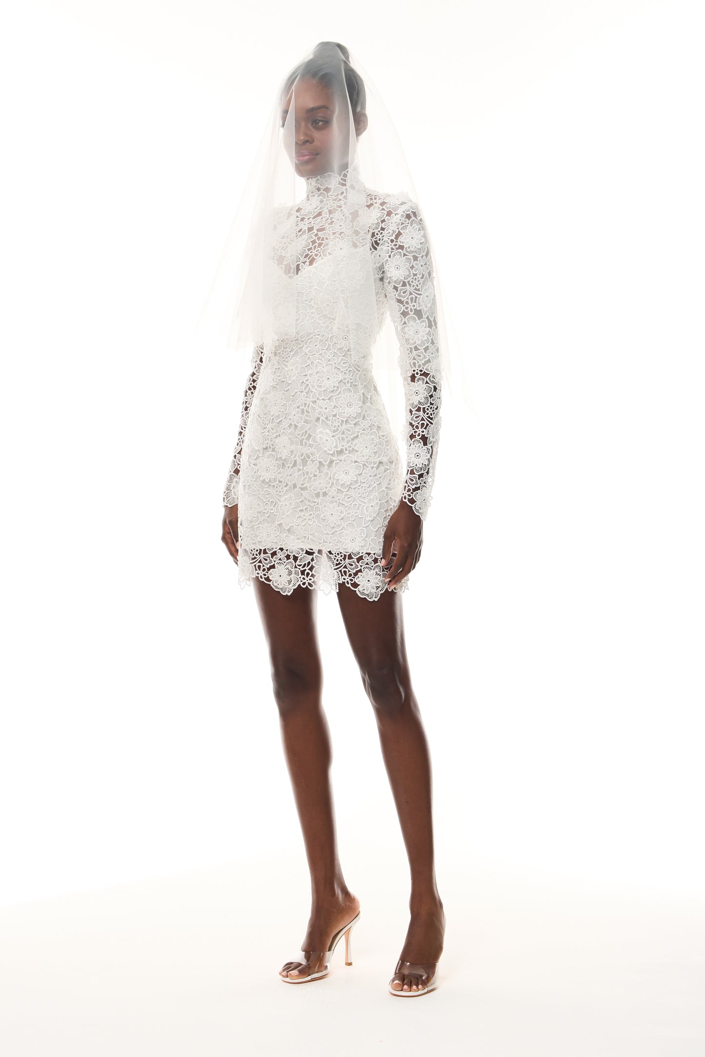 Monique Lhuillier Novi mini dress from The Bridal Edit - Silk White Guipure lace with long sleeves and high-neck - side.