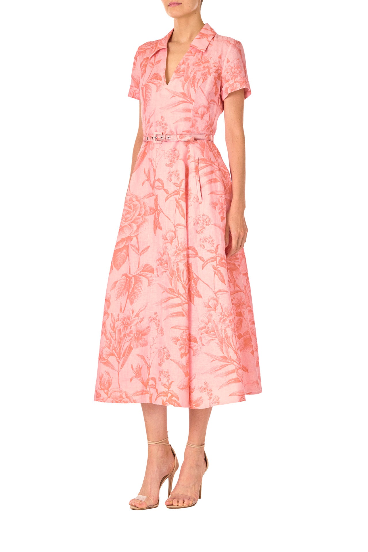 Monique Lhuillier Spring 2025 Floral printed linen dress with a-line skirt, short sleeves and pockets in Rosette Coral - left side.