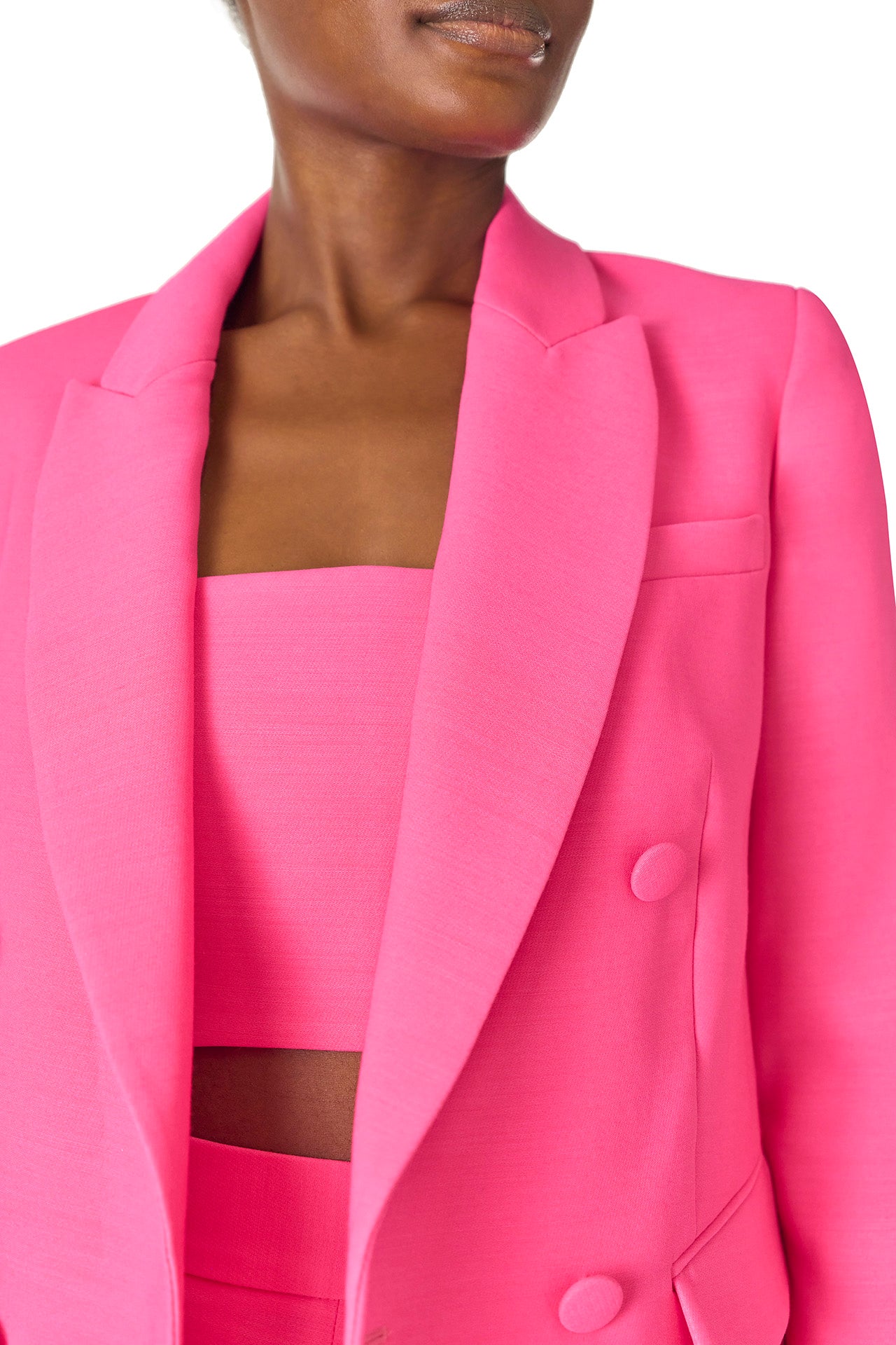 Monique Lhuillier Spring 2025 double-breasted tuxedo jacket in hibiscus wool-silk suiting - detail.