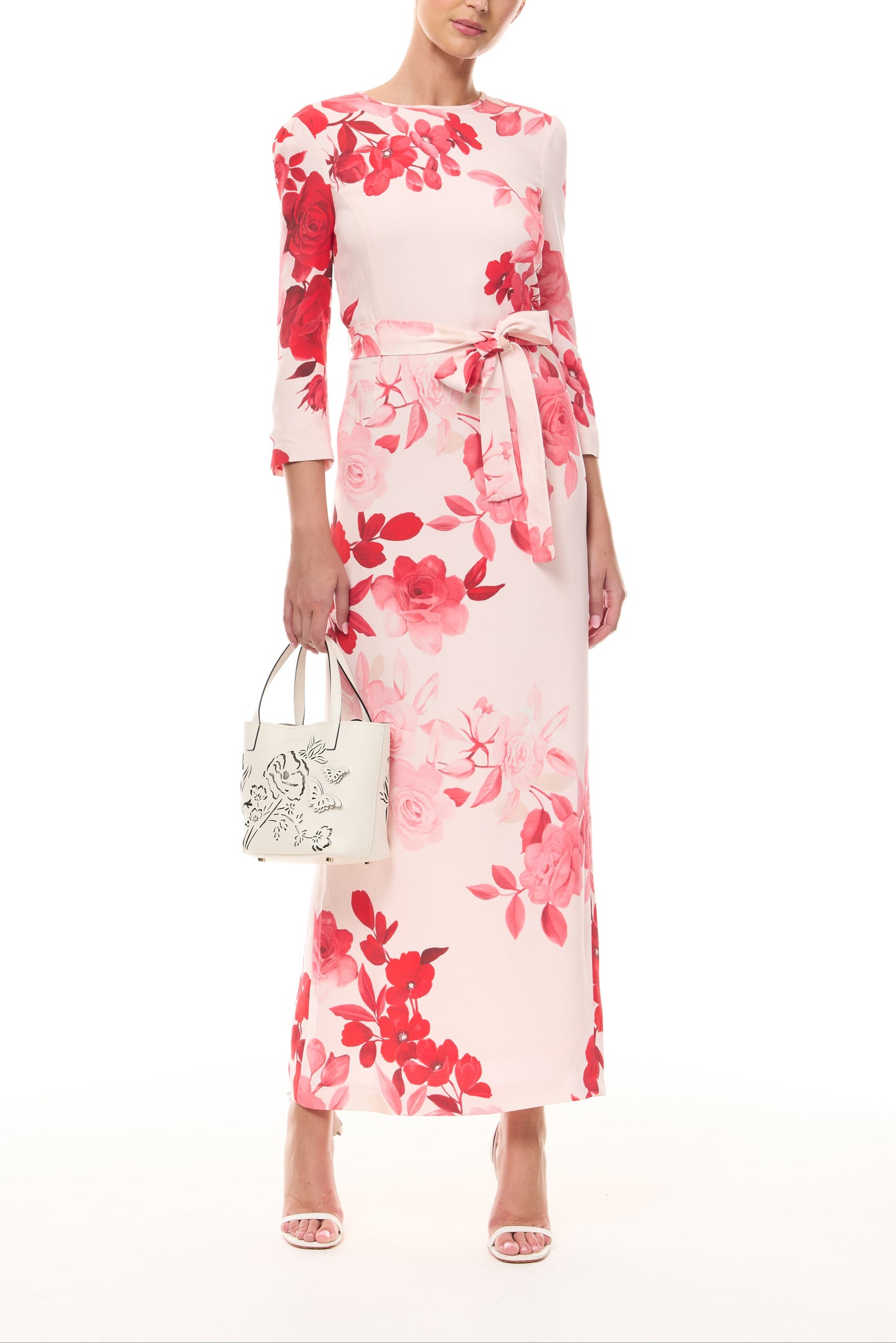 Monique Lhuillier Spring 2026 Powder Pink Multi Rose Ombre Printed Crepe Bracelet sleeve sheath dress with belt - front with ivory Colette Mini Tote Bag.