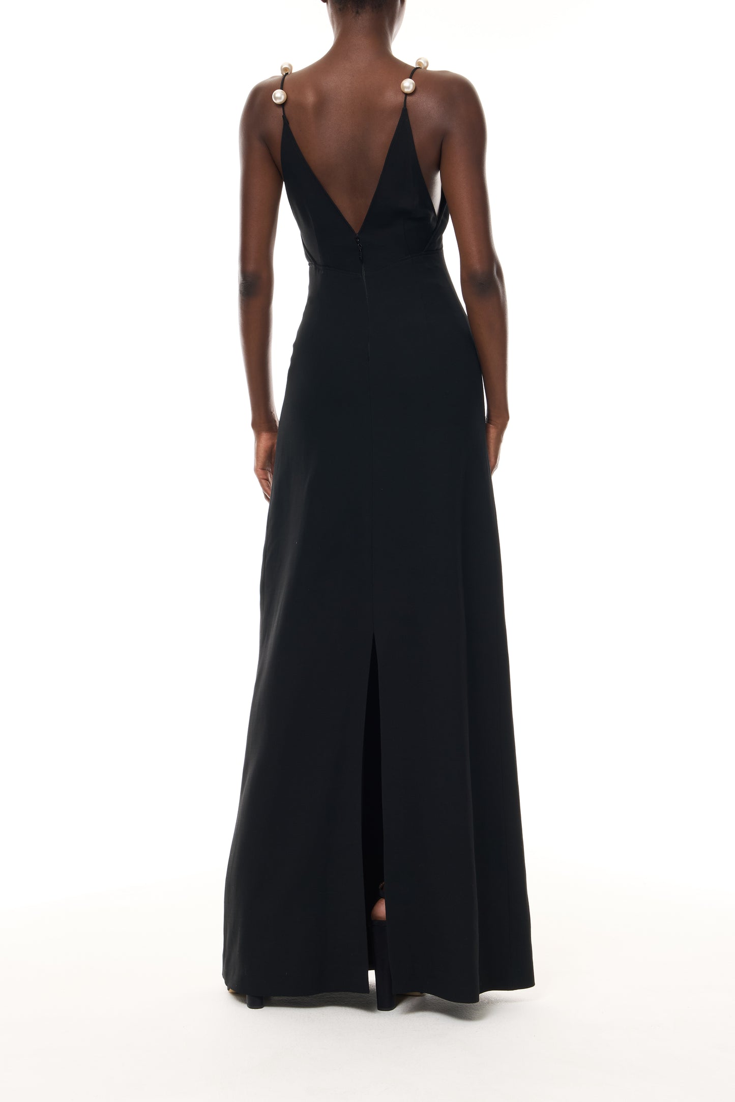 Monique Lhuillier Spring 2026 Noir Lightweight Silk Wool Suiting A - line V -neck gown with pearl ball straps -back.