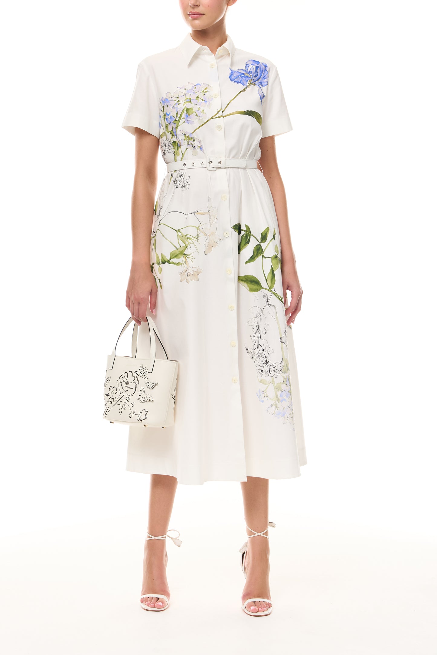 Monique Lhuillier Spring 2026 Silk White Multi Iris Bouquet Printed Cotton Poplin short-sleeved shirt dress with belt - front with Ivory Colette Mini Tote Bag.