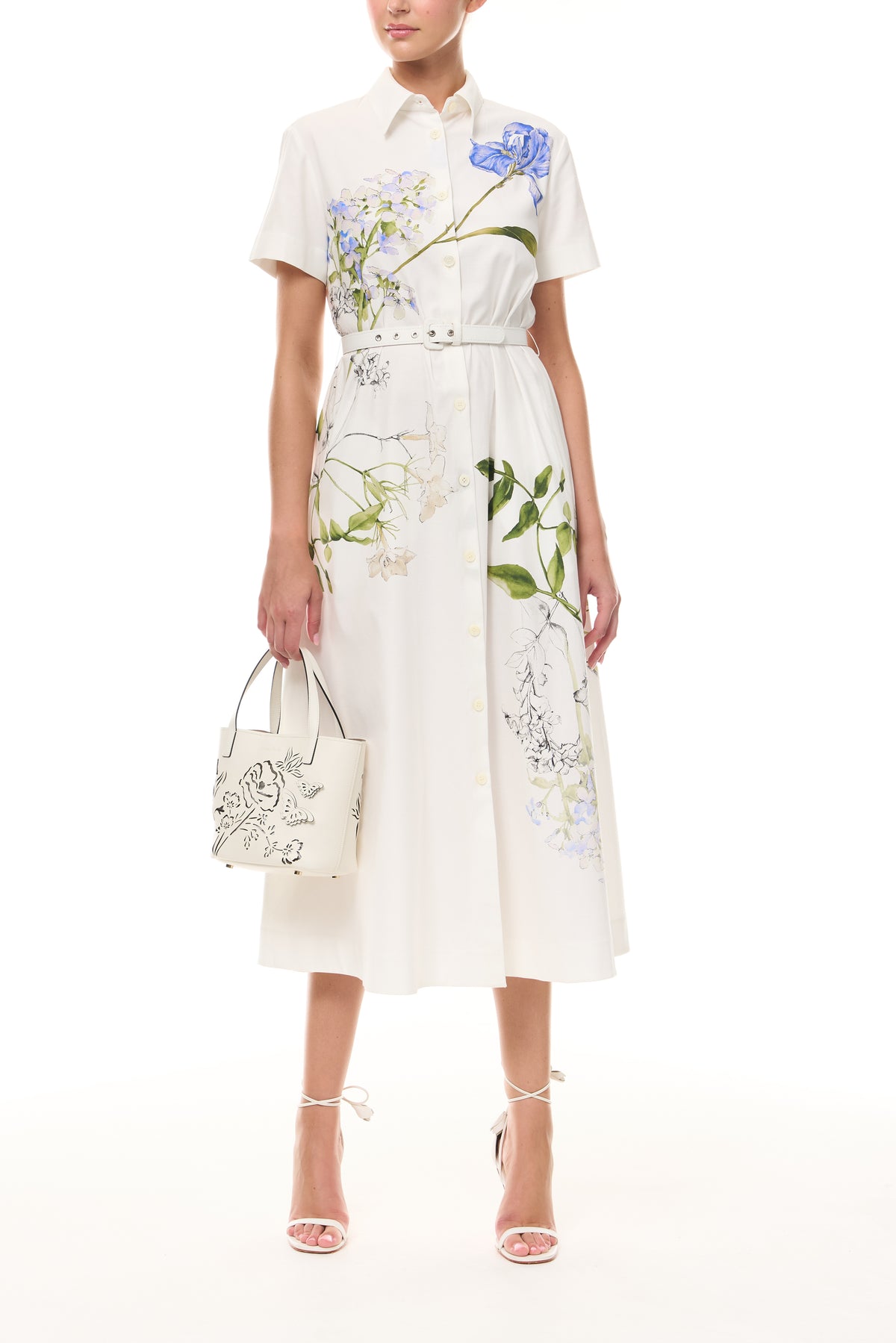 Monique Lhuillier Spring 2026 Silk White Multi Iris Bouquet Printed Cotton Poplin short-sleeved shirt dress with belt - front with Ivory Colette Mini Tote Bag.