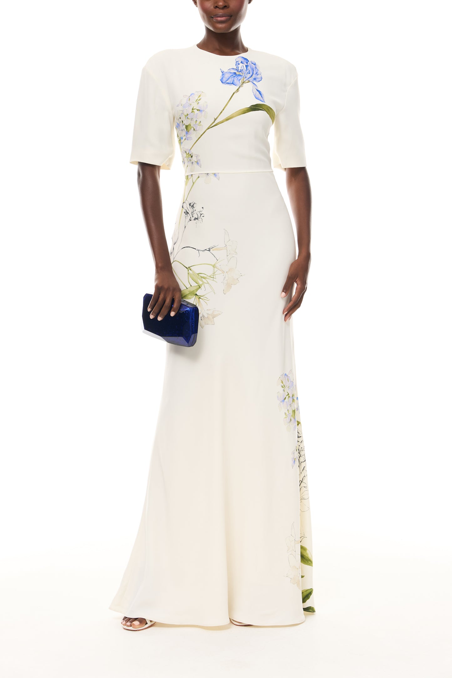 Monique Lhuillier Spring 2026 Ivory/Multi Iris Bouquet Printed CrepeShort sleeve bias gown - front with Blue Dasha Minaudière