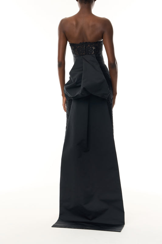 Monique Lhuillier Fall 2026 Strapless Midi Cocktail Dress in Noir Peony lace with Noir Silk Faille sash and train - back.