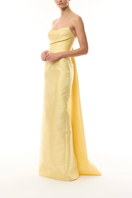 Monique Lhuillier Fall 2026 Pale yellow Mikado Piqué strapless column gown with train - side.