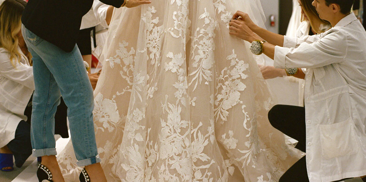 Behind the scenes - design team working on Cameo/Silk white Maeve wedding gown in the atelier.