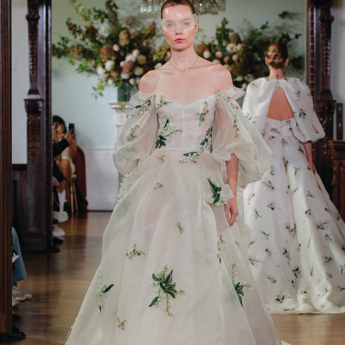 Monique Lhuillier Fall 2026 Bridal Silk white/multi silk organza and embroidered off-the-shoulder Freya ballgown with floral detail and tufted skirt -runway.