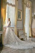 Woman wearing Monique Lhuillier Fall 2020 white lace strapless Emilia ballgown with matching long-sleeve high neck jacket