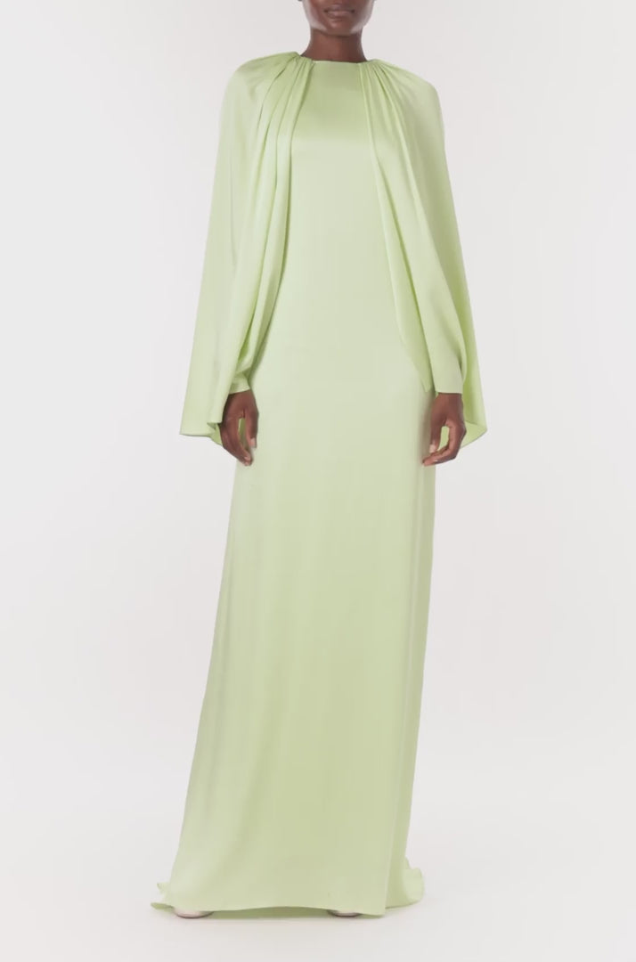 Monique Lhuillier Spring 2024 floor length capelet gown with jewel neckline in honeydew colored crepe back satin - video.