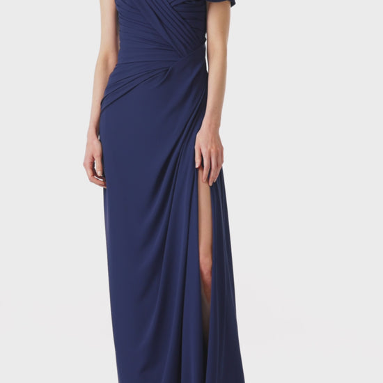 Monique Lhuillier navy gown with draped neckline and high leg slit in jersey chiffon fabric.