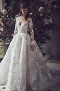 Woman wearing Monique Lhuillier Fall 2019 white and blush floral embroidered applique Maeve ballgown with matching long sleeve jacket