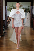 Monique Lhuillier Fall 2026 Bridal silk white/pearl lace scoop neck Rhiannon mini dress with silk white duchess satin Rhiannon billow sleeve jacket- runway.