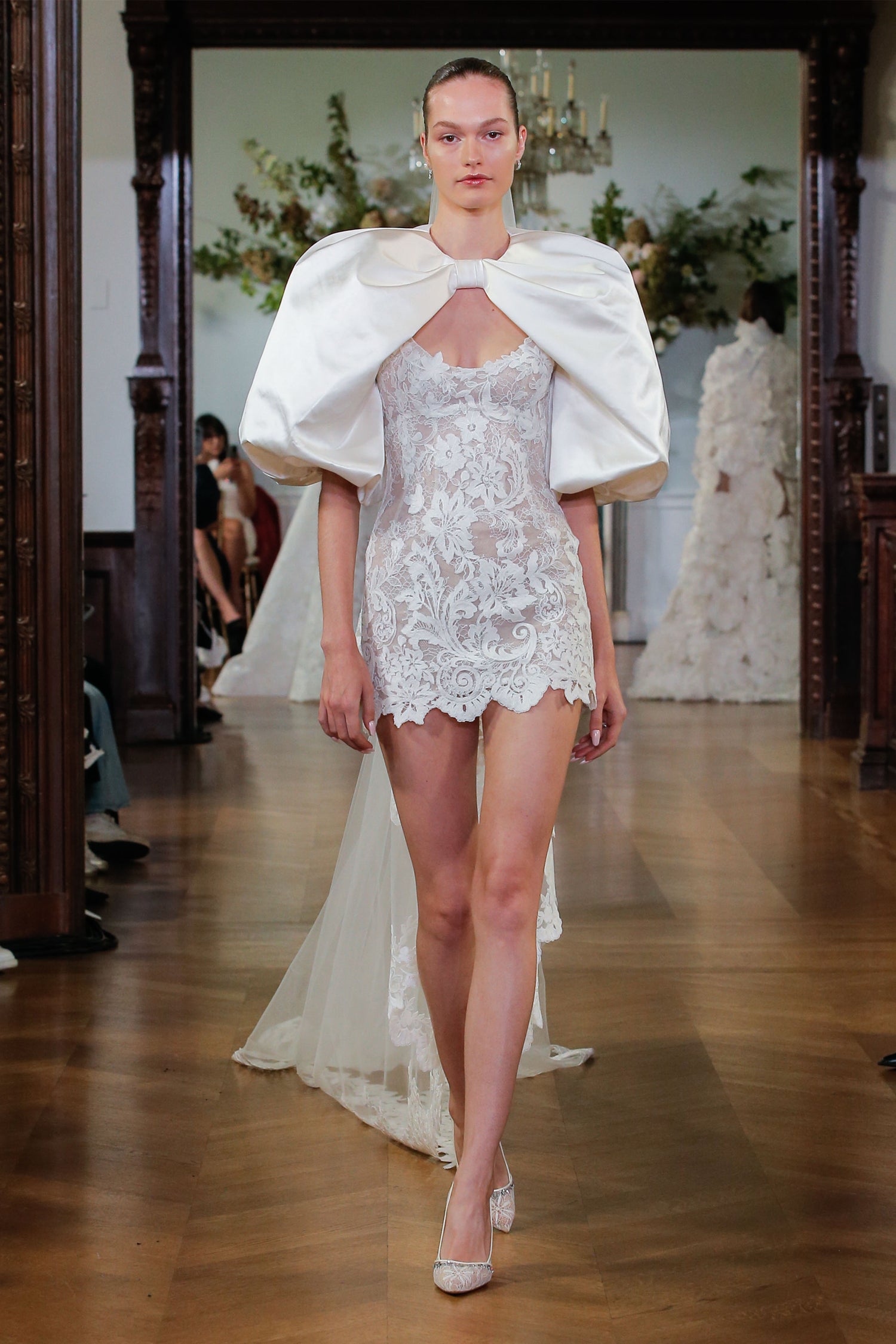 Monique Lhuillier Fall 2026 Bridal silk white/pearl lace scoop neck Rhiannon mini dress with silk white duchess satin Rhiannon billow sleeve jacket- runway.