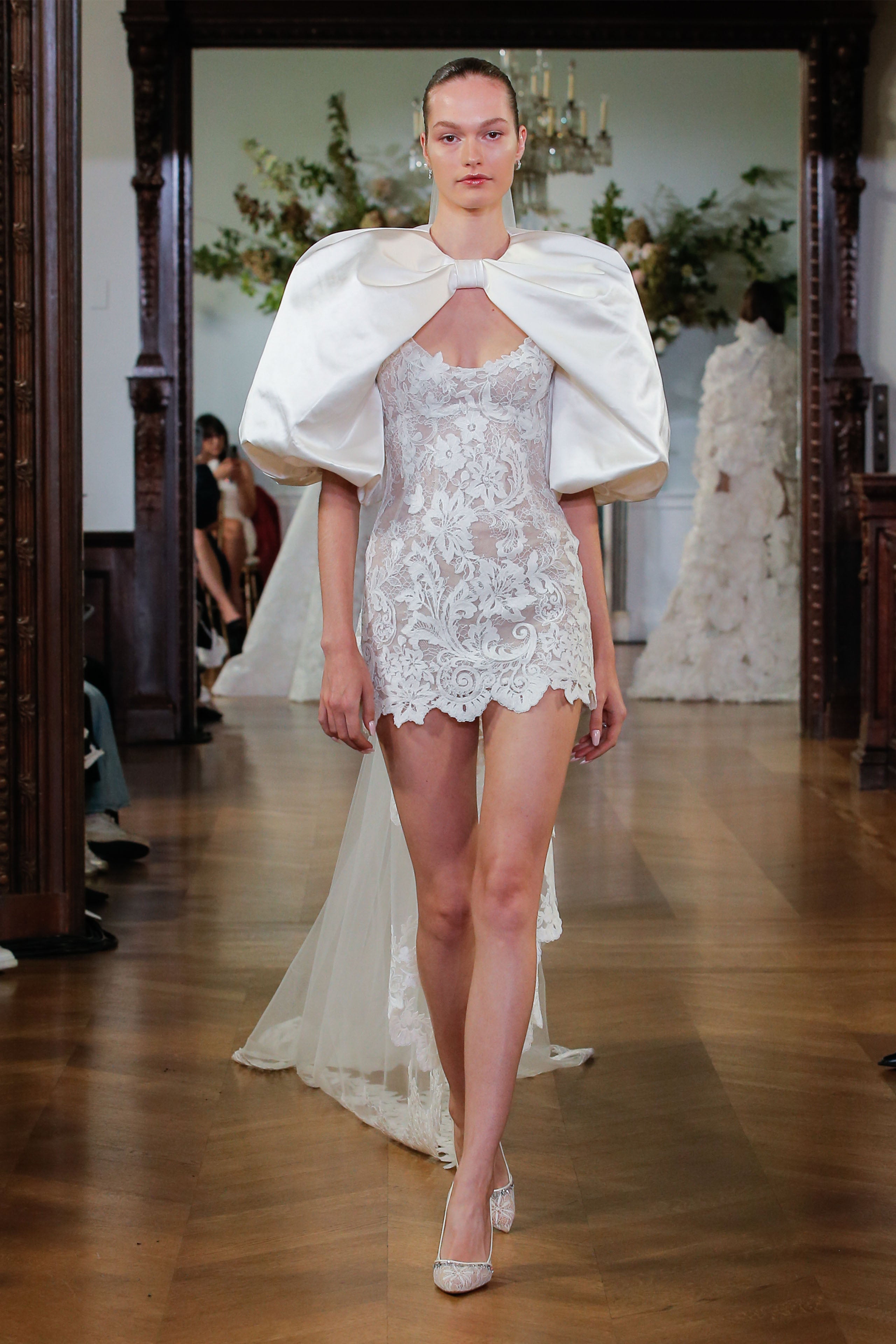 Monique Lhuillier Fall 2026 Bridal silk white/pearl lace scoop neck Rhiannon mini dress with silk white duchess satin Rhiannon billow sleeve jacket- runway.