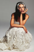 Monique Lhuillier Spring 2027 Bridal Strapless sweetheart June ball gown in silk white three-dimensional embroidered lace.