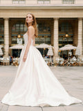 Woman wearing Monique Lhuillier Spring 2024 Bliss white strapless mikado BL24101 ballgown