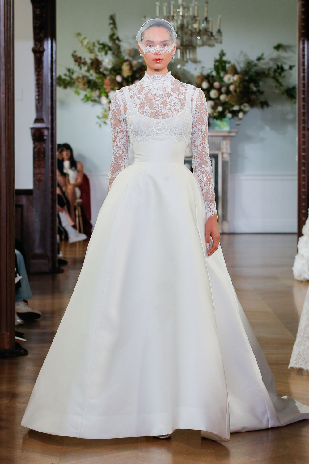 Monique Lhuillier Fall 2026 Bridal silk white lace and Mikado scoop neck Keaton ballgown with long sleeve high neck lace cropped Keaton jacket - runway.