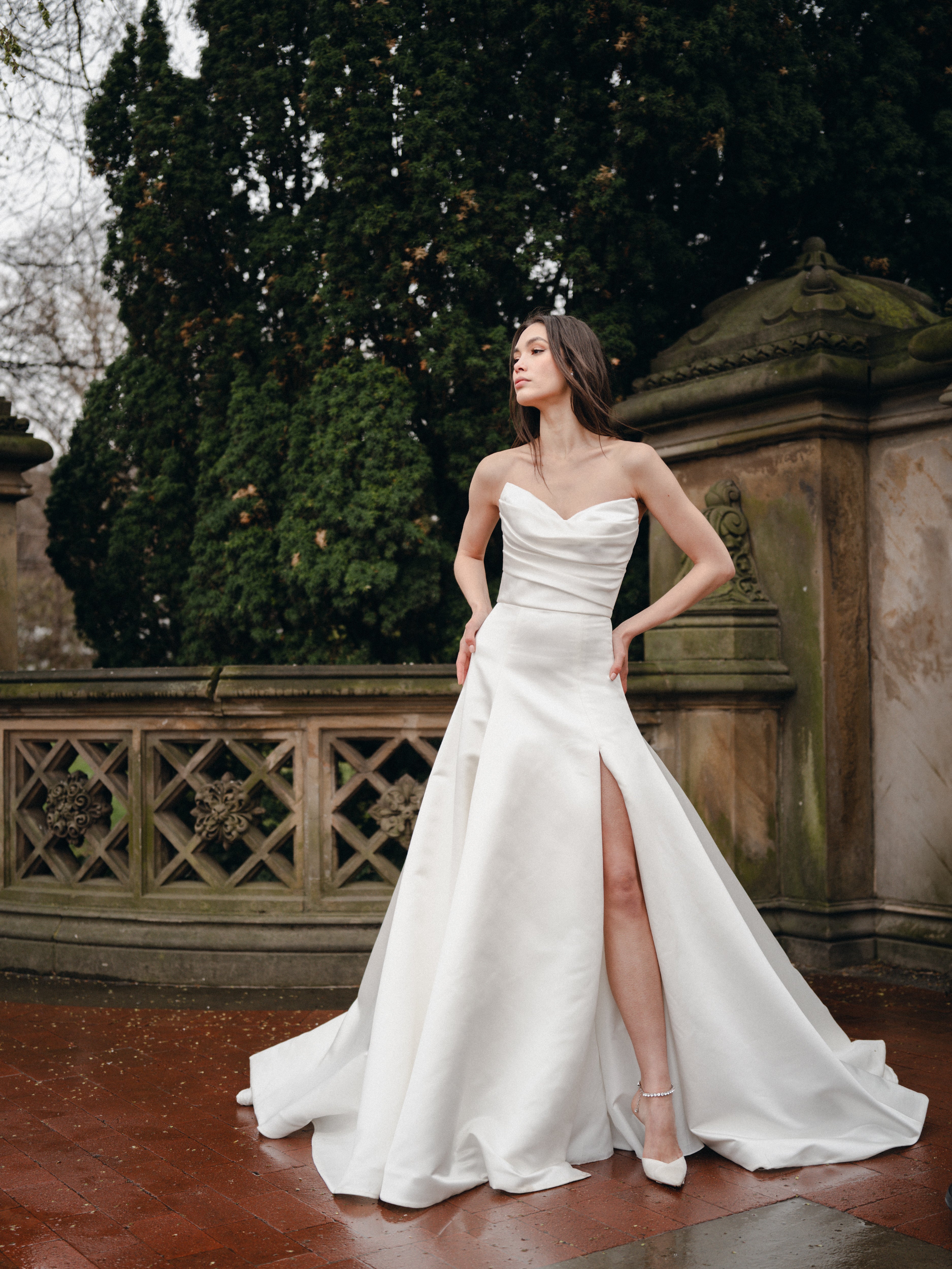 Satin a-line gown with sweetheart, draped bodice and skirt slit.