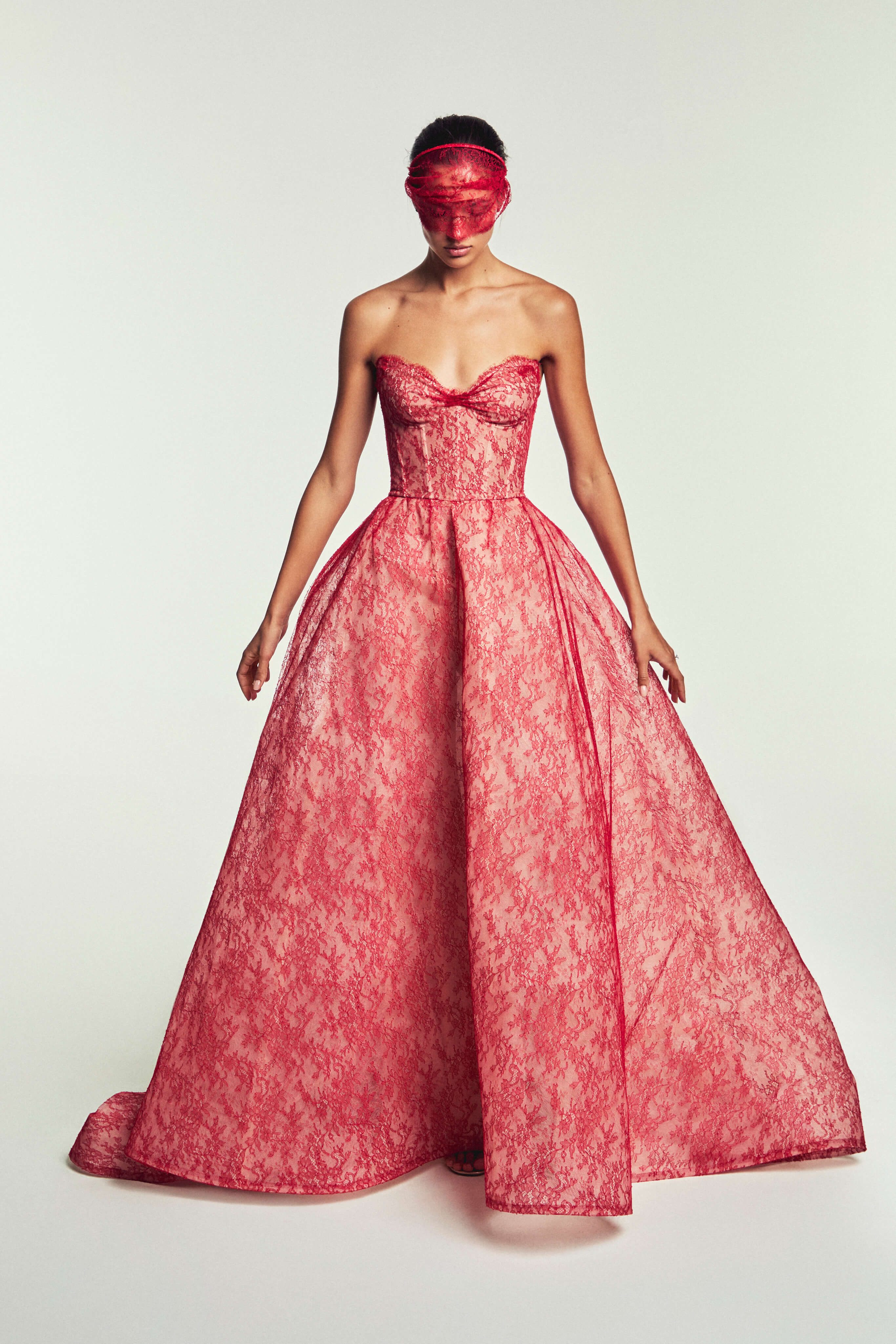 Monique Luillier Spring 2027 Bridal Strapless sweetheart Rouge ballgown in scarlet and nude Chantilly lace with head band with lace veilette.