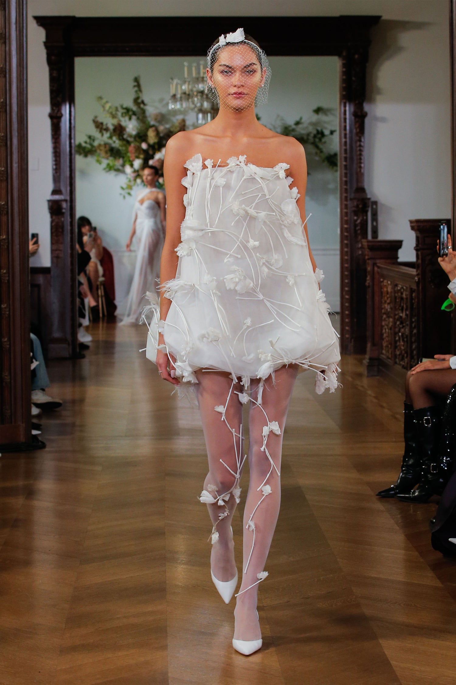 Monique Lhuillier Fall 2026 Bridal silk white organza bubble hem Poppy cocktail dress with three dimensional floral embroidery and feather detail - runway.
