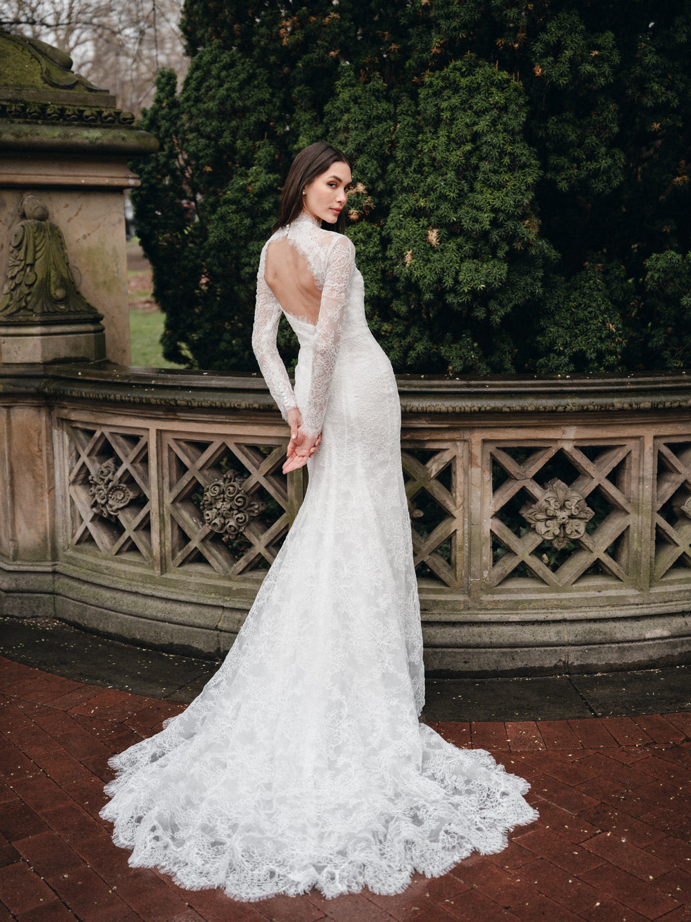 High neck lace trumpet gown with long sleeves and keyhole back.
