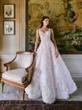 Woman wearing Monique Lhuillier Fall 2024 white Candlelight ballgown with 3-d floral embroidered lace