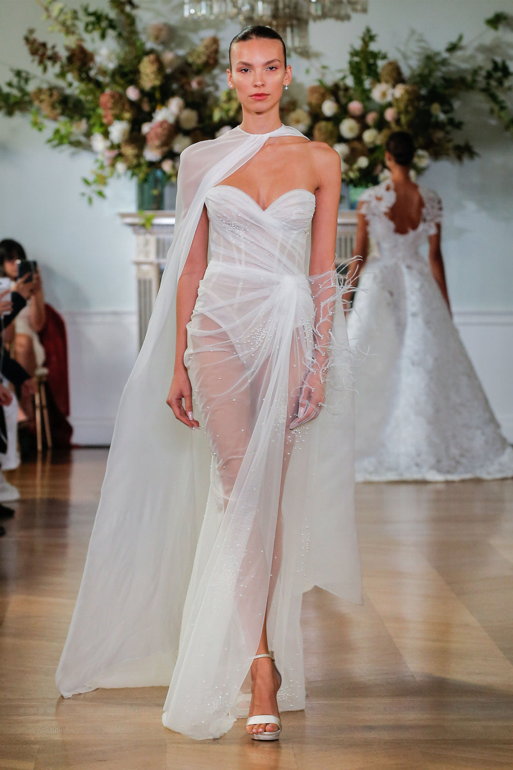 Monique Lhuillier Fall 2026 Bridal silk white tulle strapless draped sheath Calypso gown with pearl embroidery and  high slit - runway.