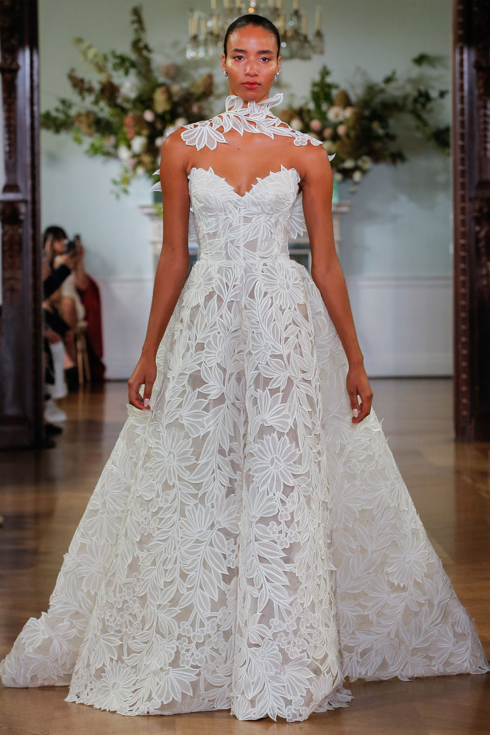 Monique Lhuillier Fall 2026 Bridal Ivory laser cut organza lace strapless Marisol ballgown with attached floral integral wrap - runway.