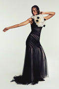 Monique Lhuillier Spring 2027 Bridal Hand draped Raven trumpet gown with halter neckline in noir and silk white Spanish tulle and ruffled neck collar with floral detail in silk white and noir satin faced organza.