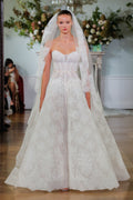 Monique Lhuillier Fall 2026 Bridal ivory chantilly lace strapless drop waist Odette ballgown with ribbon at waist and lace-trim Odette veil - runway.