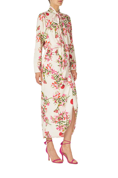 Monique Lhuillier Long sleeve dress with tie neck and faux-wrap skirt in Silk White Fuchsia floral print - right side.