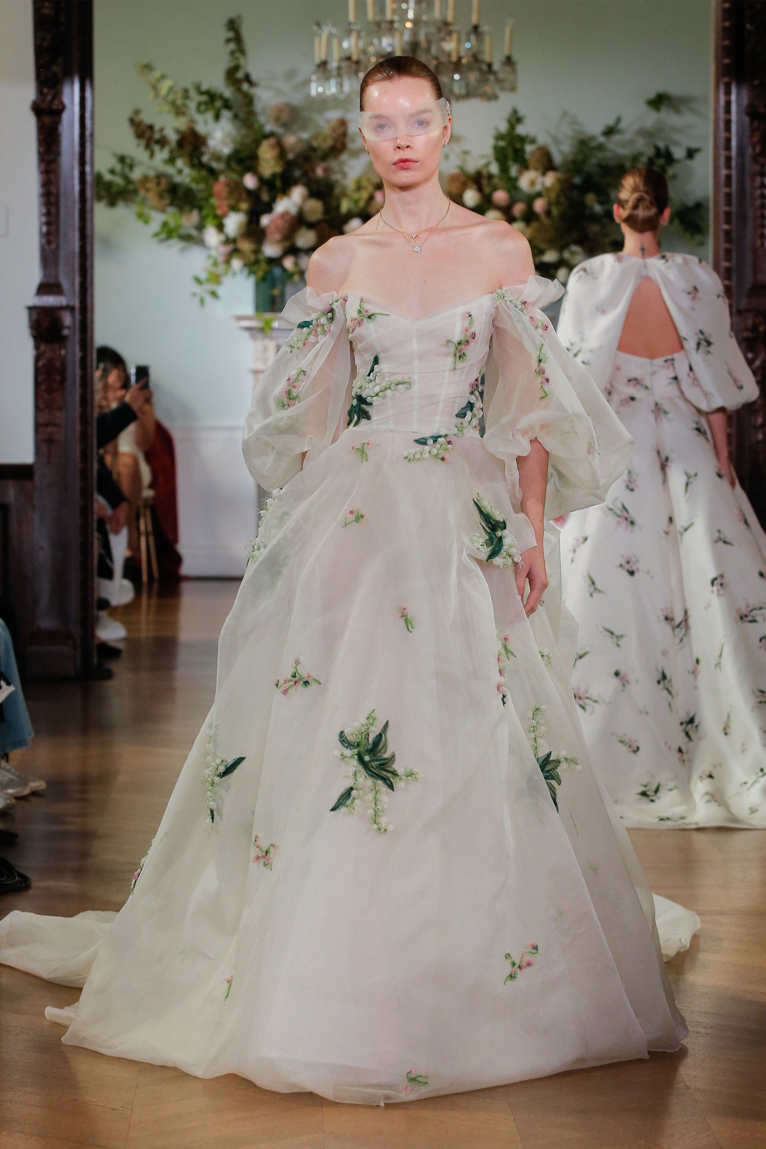 Monique Lhuillier Fall 2026 Bridal Silk white/multi silk organza and embroidered off-the-shoulder Freya ballgown with floral detail and tufted skirt -runway.