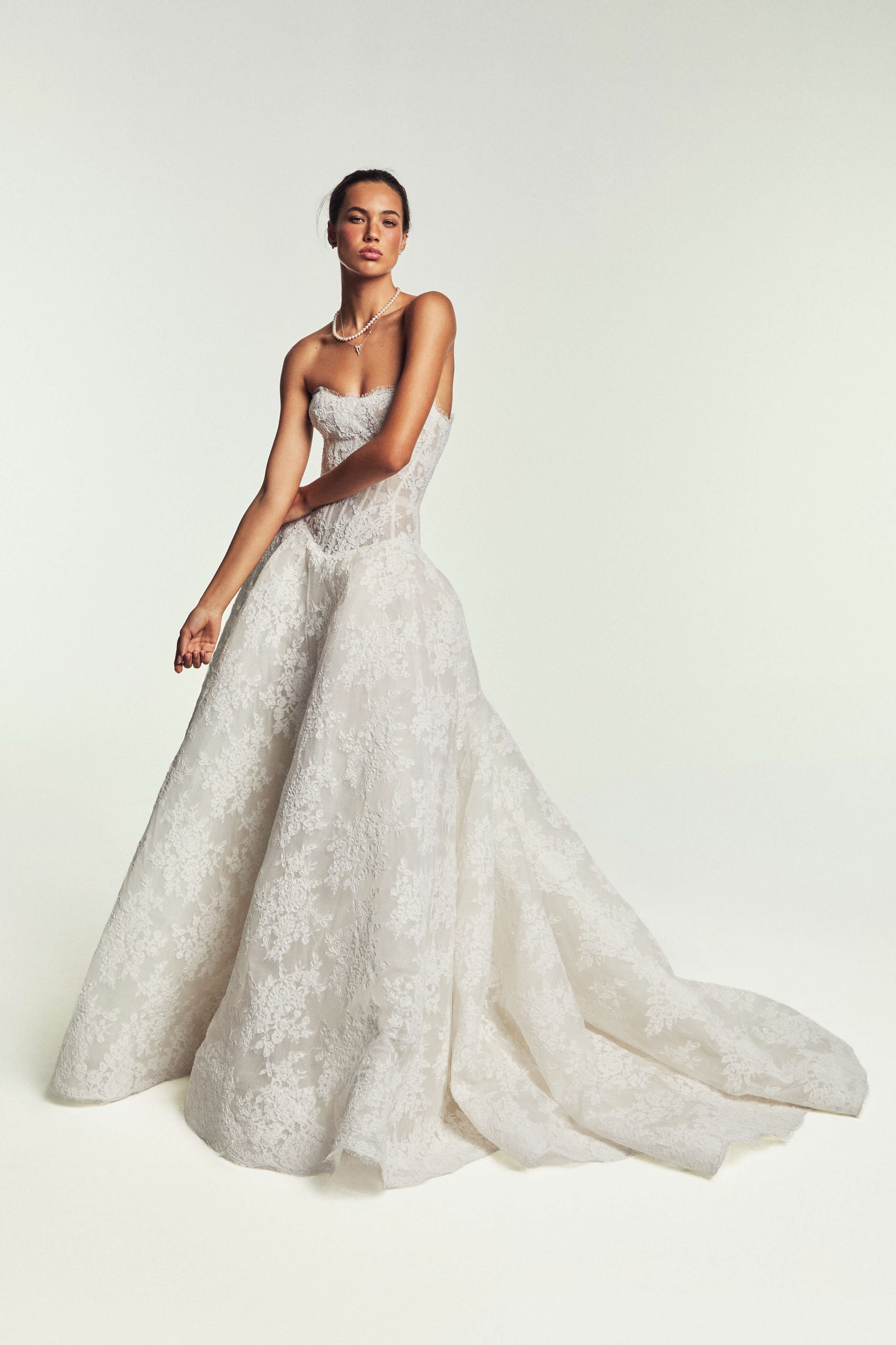 Monique Lhuillier Spring 2027 Bridal Strapless corseted basque waist Beloved ball gown in silk white re-embroidered lace.