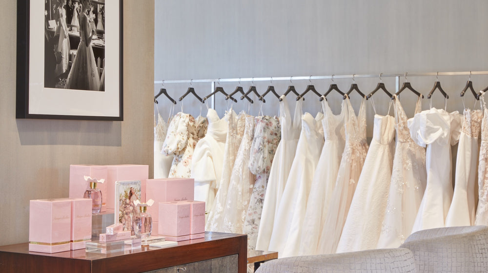 Interior of Melrose Place flagship store featuring bridal gowns and Monique Lhuillier signature fragrance display.