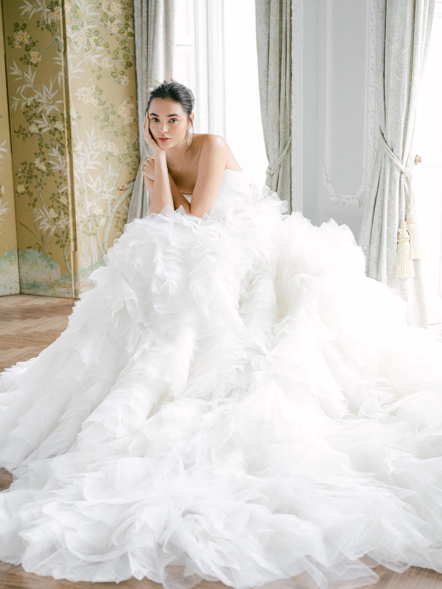 Monique Lhuillier white strapless bridal gown with full tulle skirt.