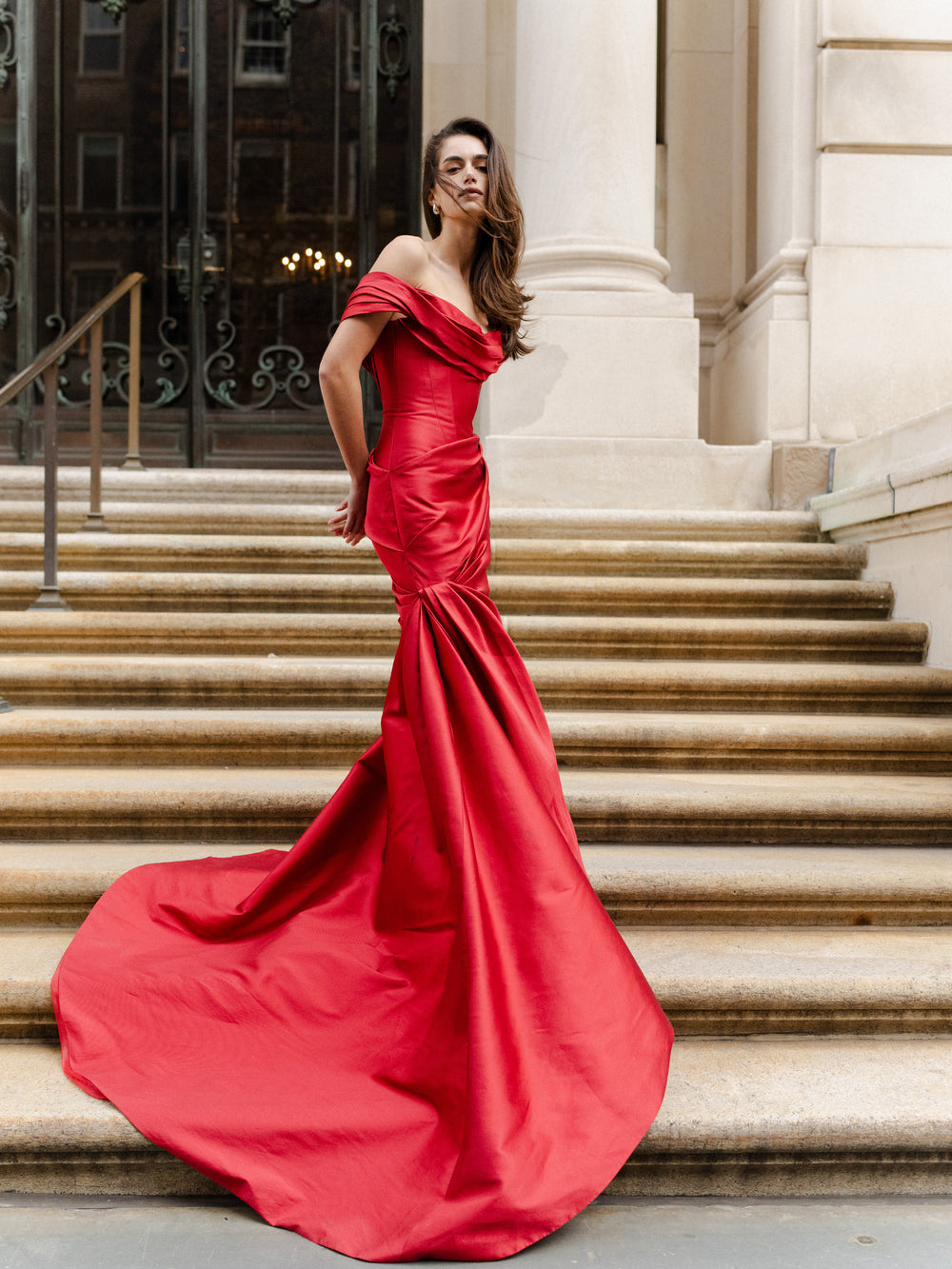 Monique Lhuillier Fall 2024 scarlet mikado, off-the-shoulder, draped gown with trumpet skirt and low back - lookbook front.