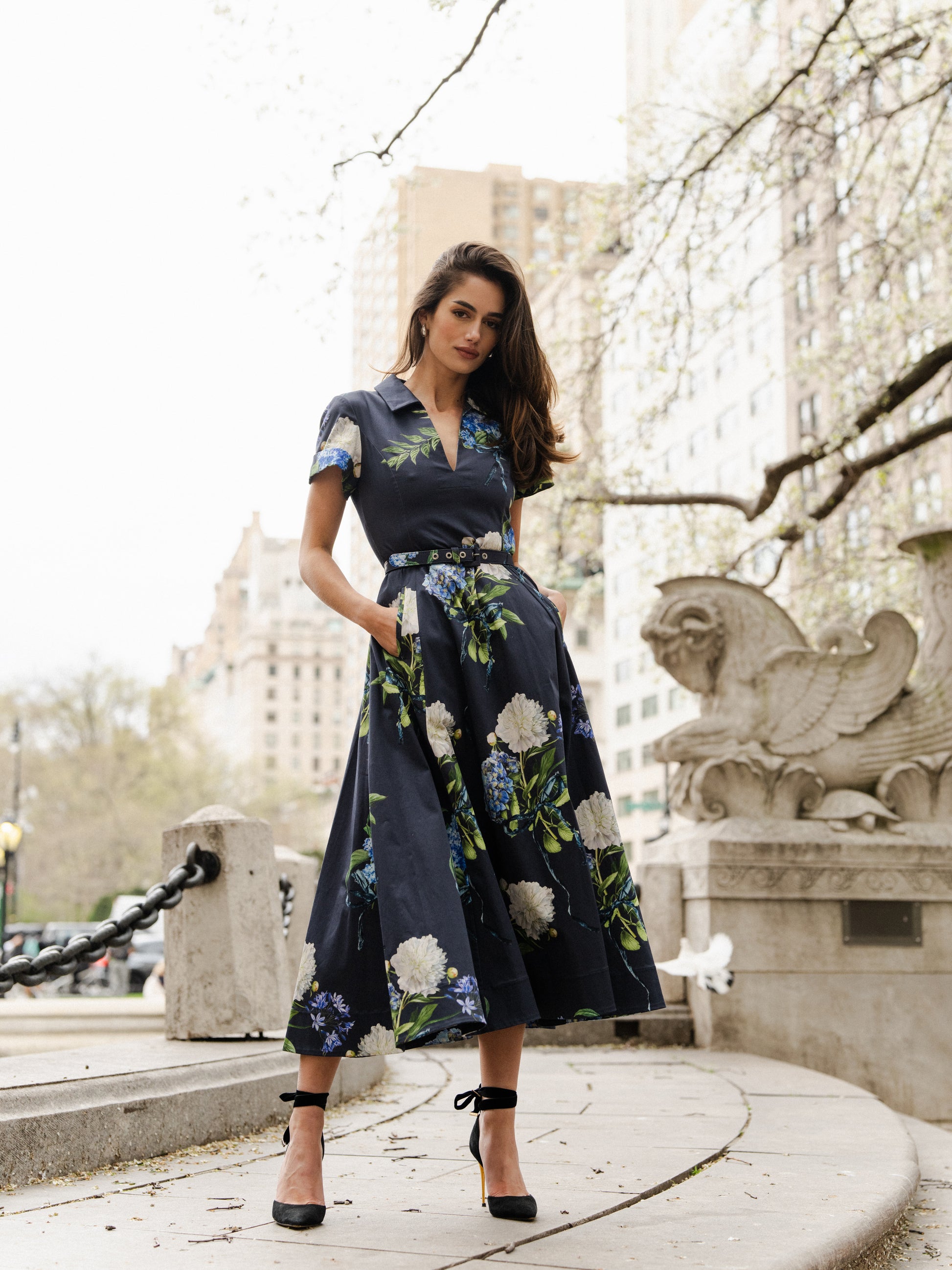 Monique Lhuillier Fall 2024 night sky floral collared, short sleeve dress with pockets, belted waist and midi a-line skirt - look book photo.