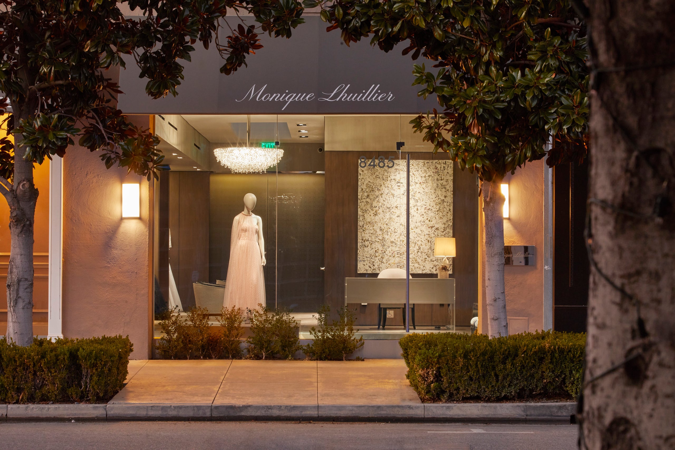 Exterior of Melrose Place flagship store, featuring Ready to Wear in the window and a crystal chandelier. 